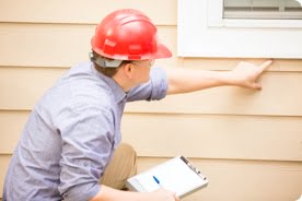 step-4-worker-inspecting-siding-on-house